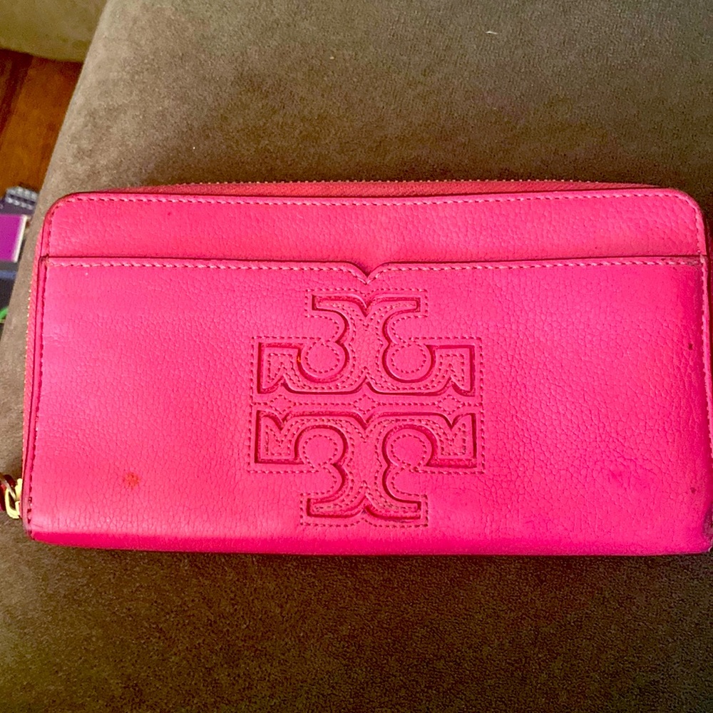 We’ll loved Tory Burch pink wallet. Works great